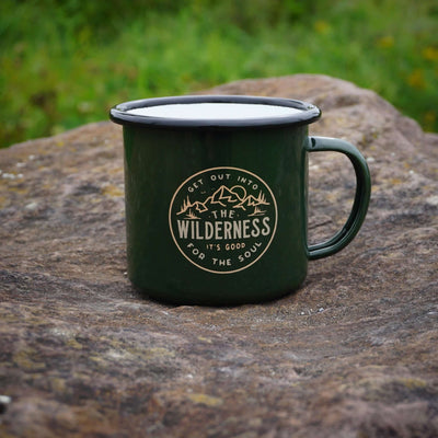 a coffee mug sitting next to a green coffee cup 
